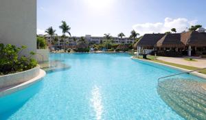 a swimming pool with blue water in a resort at Paradisus by Meliá Playa del Carmen - Riviera Maya - All Inclusive in Playa del Carmen