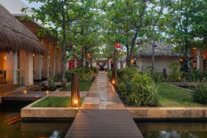 a walkway in a building with lights and trees at Paradisus by Meliá Playa del Carmen - Riviera Maya - All Inclusive in Playa del Carmen +120 photos