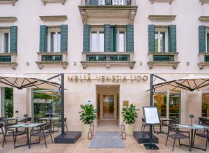 a restaurant in front of a building at Meliá Venezia Lido in Venice-Lido +67 photos
