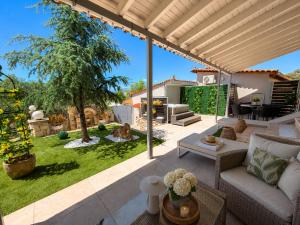 a living room with a couch and a patio at Blue Topaz cottage Mini pool Spa in Nafplio