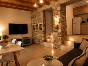 a living room with a couch and a table at Blue Topaz cottage Mini pool Spa in Nafplio