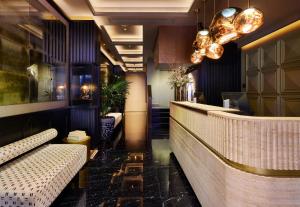 a restaurant with a bar with benches and lights at MiM Andorra member of Meliá Collection in Escaldes-Engordany