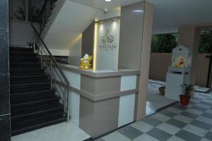 a staircase in a building with a sign on it at Hotel Shreyash in Solapur