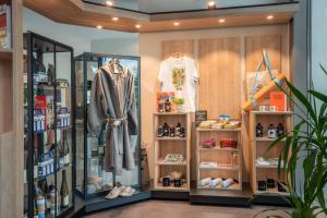 a clothing store with displays of clothes and shoes at INNSiDE by Meliá Bremen in Bremen +46 photos