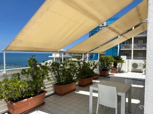 a patio with plants and a table and chairs at La mia terrazza sul mare - Mared'aMare in Bari