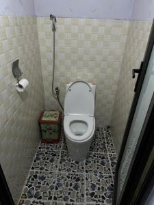 a small bathroom with a toilet in a stall at Sisi House Experience Hike & Batik Painting in Sa Pả +107 photos