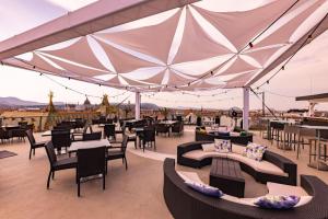 a patio with tables and chairs and a large tent at Hotel President Budapest, Affiliated by Meliá in Budapest