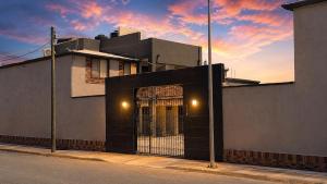 a building with a gate on the side of a street at VIRREYES418 extended apartments in Los Valdeses