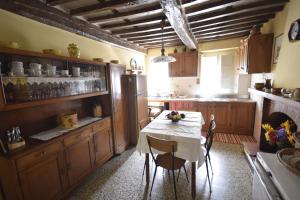 a kitchen with a table with a white table cloth at Casale Irene in Pescaglia