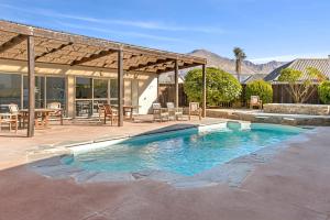a swimming pool in a yard with a house at Spacious Alpine View Resort in Wanaka