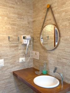 a bathroom with a sink and a mirror at Pousada Vila dos Santos in Porto De Galinhas +50 photos
