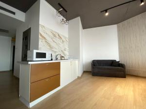 a living room with a microwave and a couch at Seven Eleven Apartment HOTEL in Most City in Dnipro