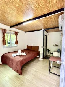 a bedroom with a large bed in a room at Chalok Garden bungalow in Ko Tao