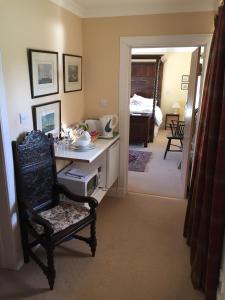 a room with a desk and a chair and a bedroom at The Annex - Easter Arr in Auldearn
