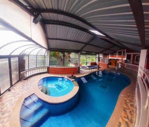 a large indoor swimming pool in a building at Hostería Agoyan Deluxe in Ulba
