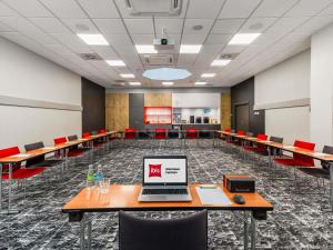 a conference room with a laptop on a table at ibis Warszawa Centrum in Warsaw