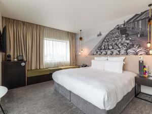 a hotel room with a large bed and a mural at Pullman Liverpool in Liverpool +118 photos