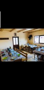a dining room with tables and chairs in a room at Cabana Codrii Apusenilor - Matis in Râșca