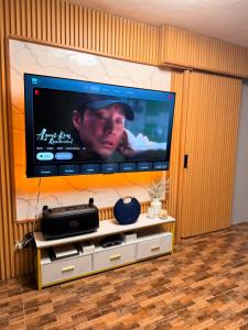 a large flat screen tv sitting on a wall at Casa De Jumeirah in Bacolod