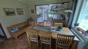 a kitchen and dining room with a table and chairs at Lapland Snow Cabin in Masugnsbyn