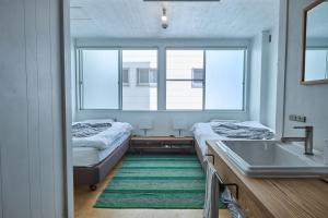 a bathroom with two beds and a sink and a mirror at WhyKumano in Nachikatsuura +119 photos