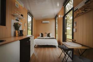 a bedroom with a bed in the middle of a room at One Gaea by Tiny Away in Rainbow Flat