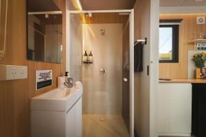 a small bathroom with a sink and a shower at One Gaea by Tiny Away in Rainbow Flat