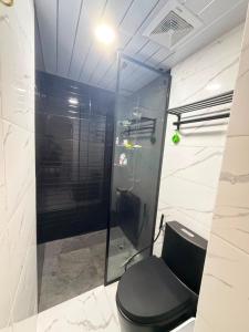 a bathroom with a toilet and a glass shower at Casa De Jumeirah in Bacolod +12 photos