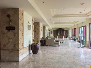 a lobby with couches and chairs in a building at Langkawi Lagoon Floating Resort 03 in Kampung Padang Masirat +69 photos