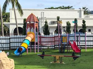 a playground in a park with a slide and swings at Langkawi Lagoon Floating Resort 03 in Kampung Padang Masirat