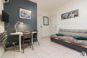 a bedroom with a bed and a table and a desk at Maison venitia t2 in Aussonne