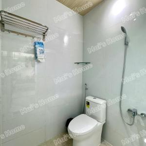 a white bathroom with a toilet and a shower at Mai Home in Ấp An Mỹ
