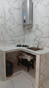 a kitchen with a sink and a counter top at Only in M'diq