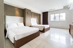 a hotel room with two beds and a window at Nicecy Ben Thanh Hotel in Ho Chi Minh City