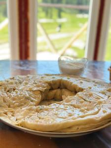 a pie sitting on a plate on a table at OrdoLife in Mineralʼnyy Istochnik Altyn-Arasan +26 photos