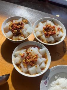 three bowls of food on a table with rice at OrdoLife in Mineralʼnyy Istochnik Altyn-Arasan