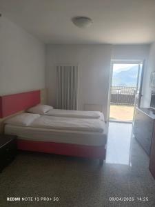 a bedroom with a bed and a large window at Casa Lampone in Trento