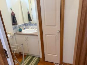a bathroom with a sink and a mirror at Bethel Homestay in Watsonia North +7 photos