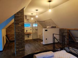 a room with a loft with a kitchen and a staircase at Casa Frida in Manđelos +23 photos