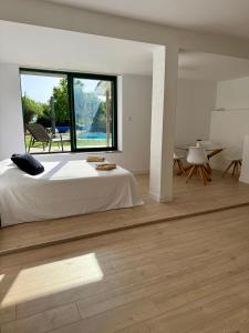 a bedroom with a large bed and a large window at La Prairie 65 in Lafitole