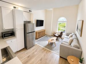 a kitchen and living room with a couch and a refrigerator at The Oak & Aura Retreat in St. Charles