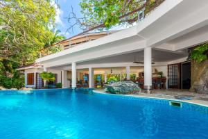 an image of a swimming pool in front of a house at Tequila Sunrise Beach Villa-Diani Beach in Diani Beach