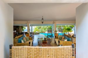 a living room with couches and a table at Tequila Sunrise Beach Villa-Diani Beach in Diani Beach