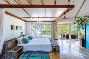 a bedroom with a bed and a large window at Tequila Sunrise Beach Villa-Diani Beach in Diani Beach +142 photos