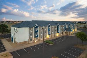 an aerial view of a hotel with a parking lot at Microtel Inn & Suites by Wyndham Denver Airport in Montbello