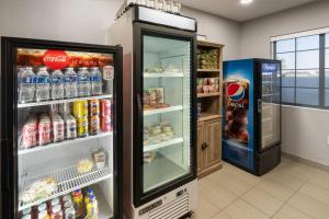 a store with an open refrigerator and a soda at Microtel Inn & Suites by Wyndham Denver Airport in Montbello