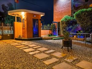 a small house with a potted plant in front of it at OLA LUXURY HOTEL Parakou in Parakou