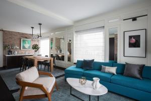 a living room with a blue couch and a table at Andaz San Diego, By Hyatt in San Diego