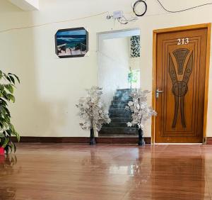 a room with a door and stairs with flowers at Black Forest Hotel in Kalām