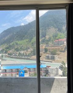a view of a mountain from a window at Black Forest Hotel in Kalām